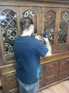 AJ installing our freshly gear painted glass into the hutch I got for a STEAL. I achieved this effect by spray painting the back of the glass dark to light.
